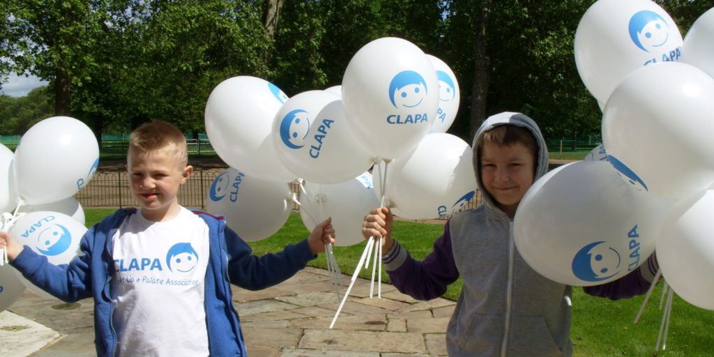 Two boys with CLAPA balloons